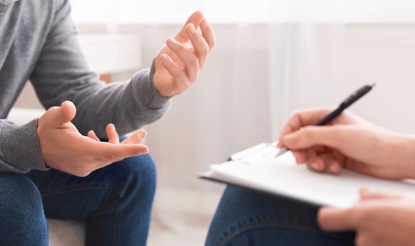 psychotherapist-writing-notes-assessing-patients-600nw-1374539876